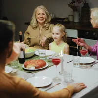 A multigenerational family sharing a warm dinner together