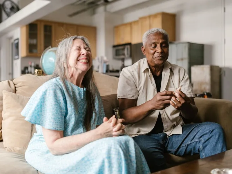 An older couple laughing together at home