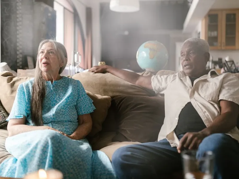 Two seniors sharing a warm conversation at home