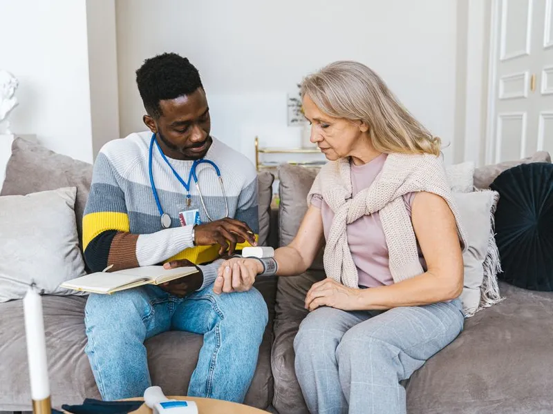 A nurse checking in with a client during a home visit